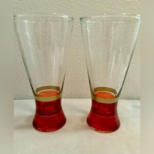 2 vintage pilsner glasses. Red with gold band glasses.  6.75” 13oz